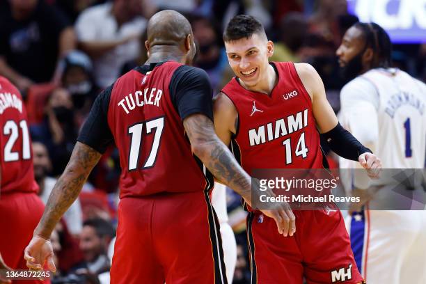 Tucker and Tyler Herro of the Miami Heat celebrate a three pointer and a foul against the Philadelphia 76ers during the first half at FTX Arena on...