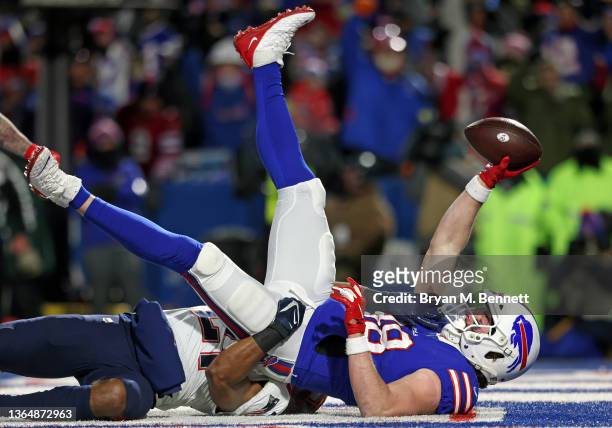 Dawson Knox of the Buffalo Bills catches a touchdown pass against Adrian Phillips of the New England Patriots during the first quarter in the AFC...