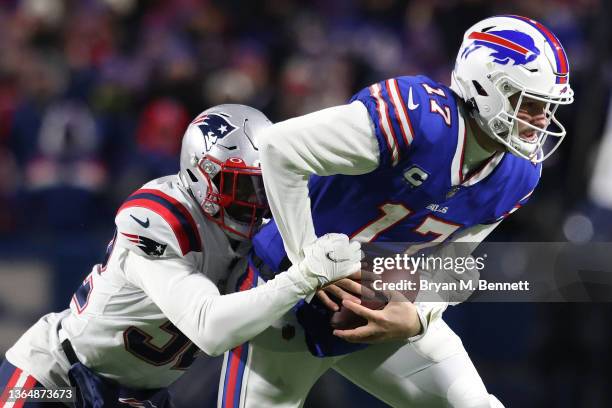 Devin McCourty of the New England Patriots tackles Josh Allen of the Buffalo Bills during the second quarter in the AFC Wild Card playoff game at...