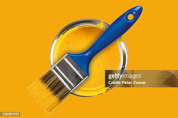 yellow paint can with brush - farbeimer stock-fotos und bilder