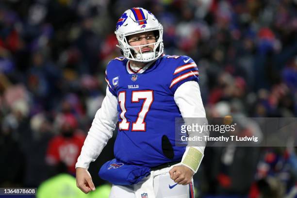 Josh Allen of the Buffalo Bills celebrates after throwing a touchdown pass against the New England Patriots during the third quarter in the AFC Wild...
