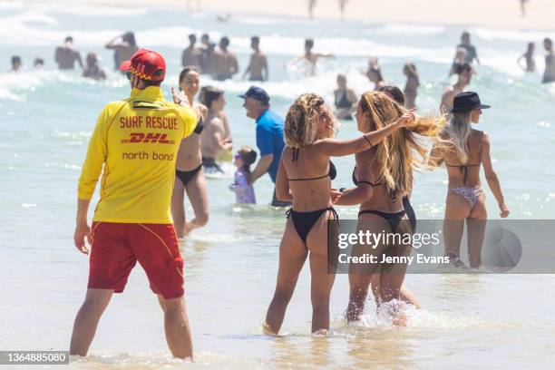 Surf rescue worker instructs swimmers to move away from the northern end of the beach at Bondi Beach on January 16, 2022 in Sydney, Australia. The...