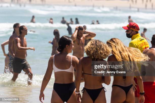 Surf rescue worker instructs swimmers to move away from the northern end of the beach at Bondi Beach on January 16, 2022 in Sydney, Australia. The...
