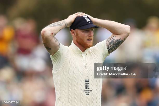 Ben Stokes of England reacts after seeing the the not out decision on the big screen after the third umpire assessed a no-ball after Alex Carey of...