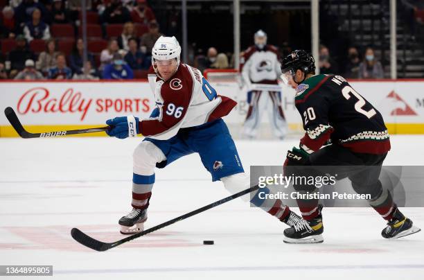 Mikko Rantanen of the Colorado Avalanche skates with the puck past Riley Nash of the Arizona Coyotes during the third period of the NHL game at Gila...