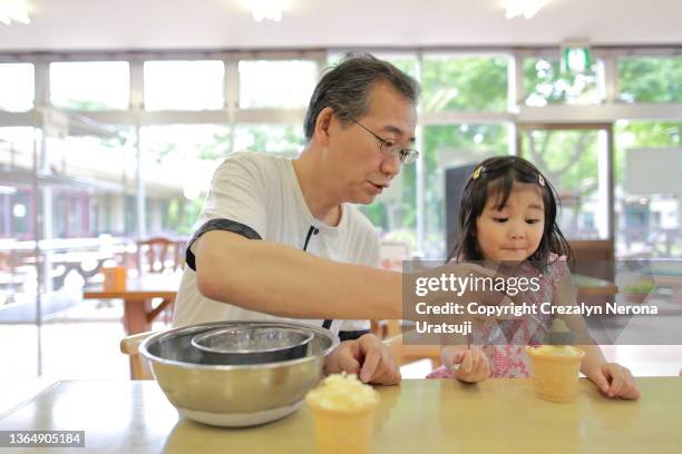 father and child doing homemade ice cream - filipino family eating stock pictures, royalty-free photos & images