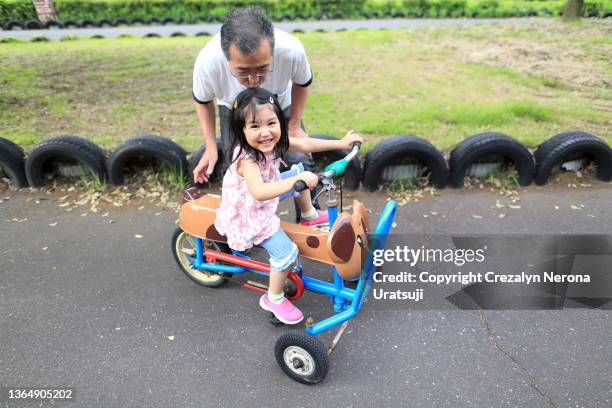 father and child bonding moment at the public park - philippines tricycle stock pictures, royalty-free photos & images