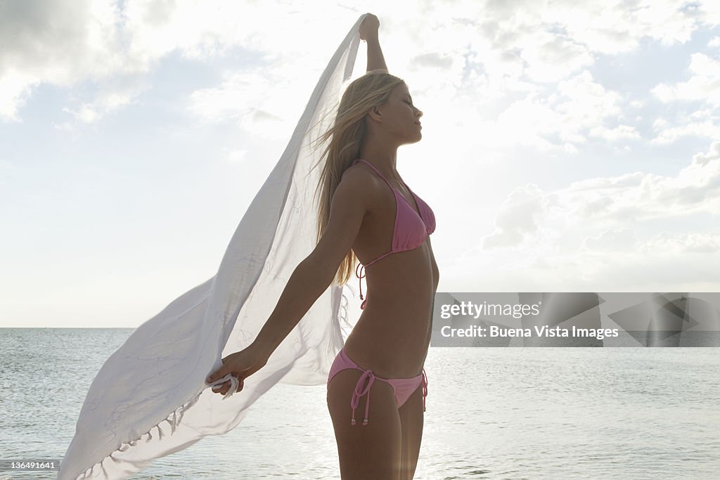 Woman with scarf on a beach