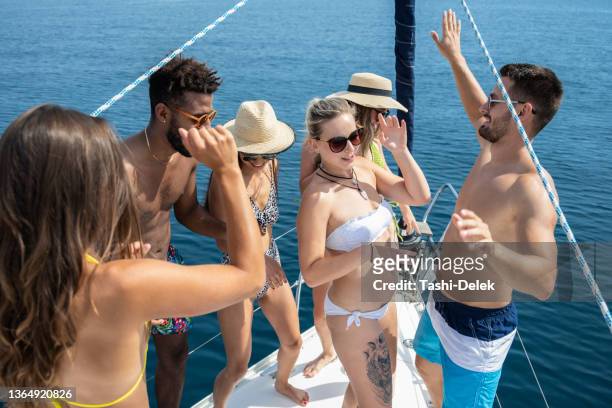 happy young friends having fun at sailboat party - sailing club stock pictures, royalty-free photos & images