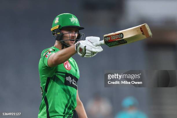 Joe Clarke of the Stars raises his bat after scoring a half century during the Men's Big Bash League match between the Melbourne Stars and the...