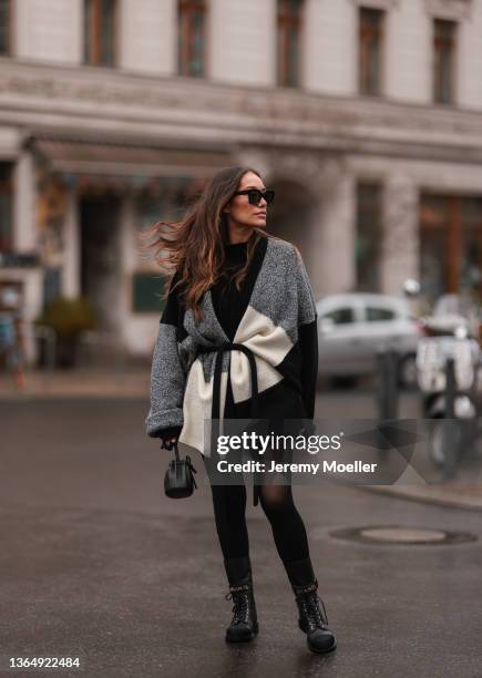 Anna Schürrle wearing black Chanel boots, black by Aylin Koenig knit sweater, black and white Barena cardigan, black Mansur Gavriel mini bag and...