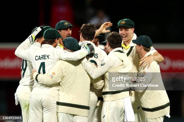 Pat Cummins of Australia celebrates the wicket of Mark Wood of England during day three of the Fifth Test in the Ashes series between Australia and...