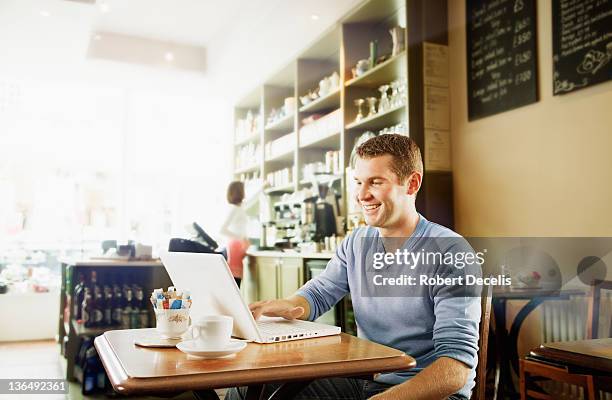 man on laptop in cafe - newfriendship stock pictures, royalty-free photos & images