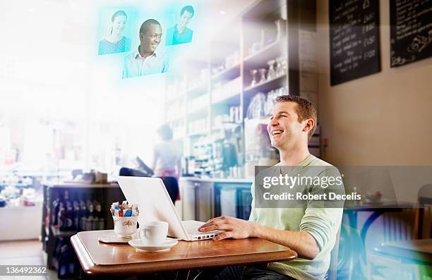 man communicating with friends in laptop in cafe - newfriendship stock pictures, royalty-free photos & images