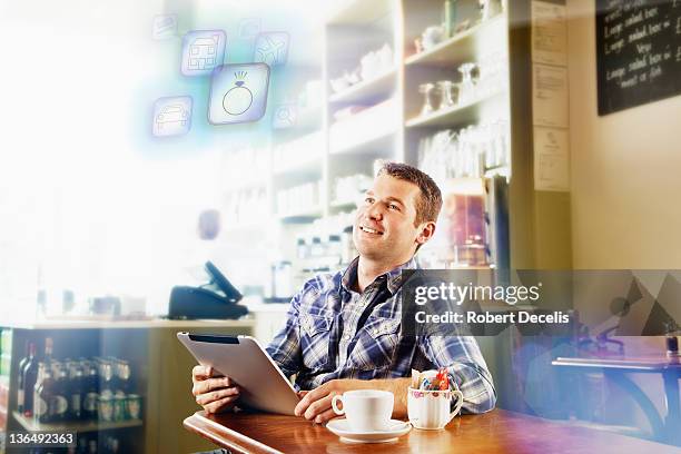 man in cafe using wireless technology - newfriendship stock pictures, royalty-free photos & images
