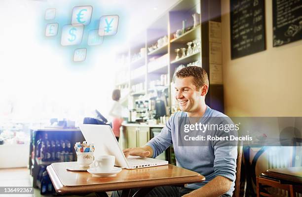 man using laptop in cafe - newfriendship stock pictures, royalty-free photos & images