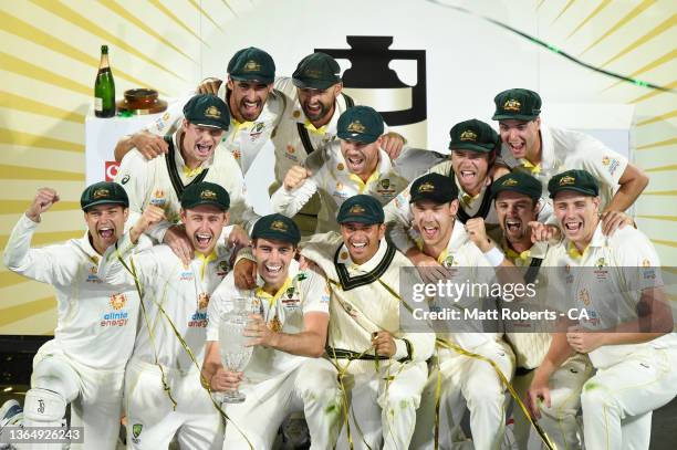 Australia celebrate on stage after winning the Fifth Test in the Ashes series between Australia and England at Blundstone Arena on January 16, 2022...