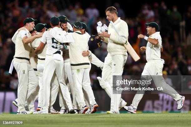 Australia celebrate victory during day three of the Fifth Test in the Ashes series between Australia and England at Blundstone Arena on January 16,...