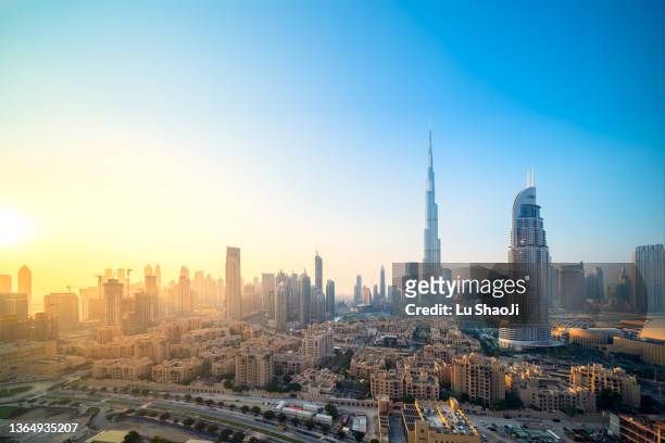 high angle view of modern city skyline and cityscape at sunset in dubai uae. - middle east stock-fotos und bilder