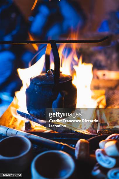 making coffee in traditional big kettle on campfire, swedish lapland - finnisch lappland stock-fotos und bilder