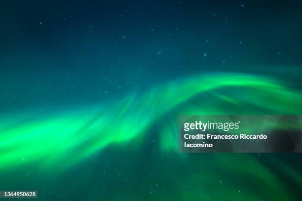 northern lights, aurora borealis on a blue night sky,  swedish lapland, during winter polar nights. sweden - northern light photos et images de collection