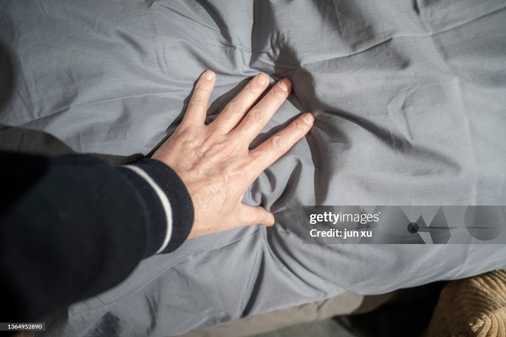 Soft grey quilt in her hand