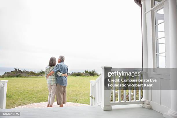 senior couple on porch, rear view - back porch stockfoto's en -beelden
