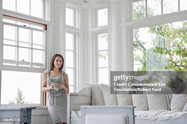 woman in living room, portrait, smiling - beautiful living room stock-fotos und bilder