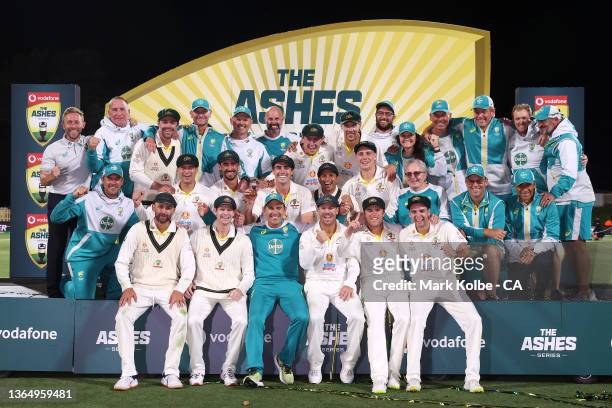 The Australian team and support staff pose as they celebrate victory during the presentation ceremony after day three of the Fifth Test in the Ashes...