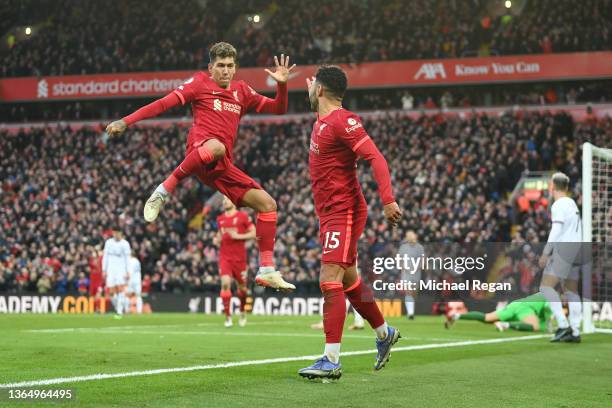 Alex Oxlade-Chamberlain of Liverpool celebrates with Roberto Firmino after scoring their team's second goall during the Premier League match between...