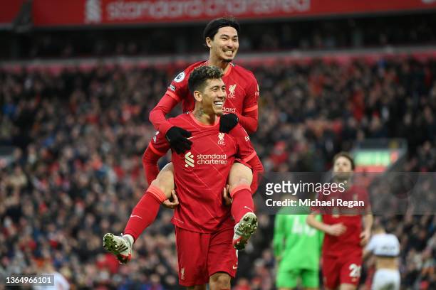 Takumi Minamino of Liverpool celebrates with Roberto Firmino after scoring their team's third goal during the Premier League match between Liverpool...