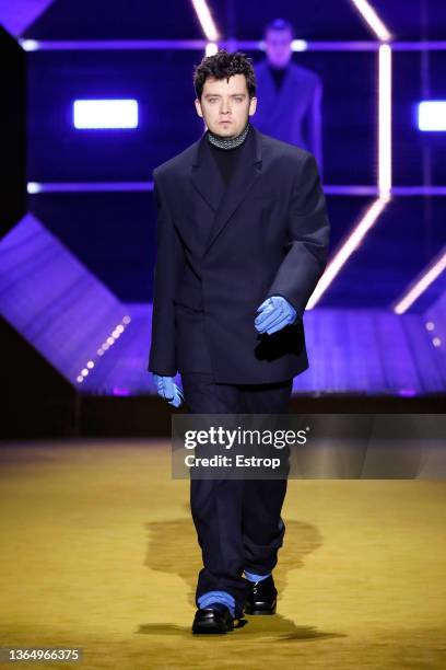 Asa Butterfield walks the runway at the Prada fashion show during the Milan Men's Fashion Week - Fall/Winter 2022/2023 on January 16, 2022 in Milan,...