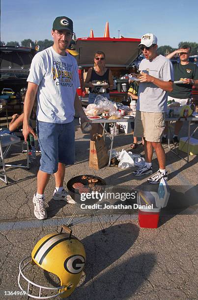 Packer fans have a tailgate barbeque party before the game between the Green Bay Packers and the Cleveland Browns at Lambeau Field on August 26,2002...