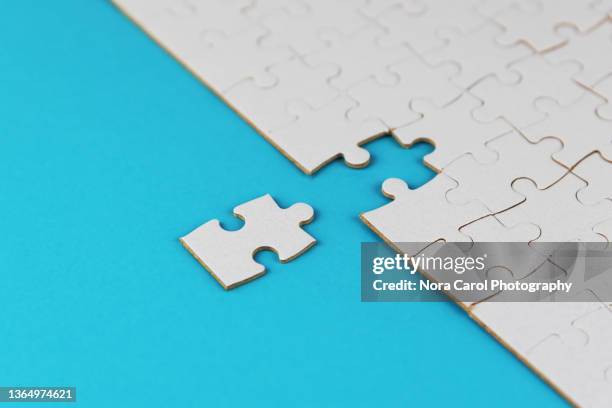 missing jigsaw puzzle on blue background - marketing tools stock pictures, royalty-free photos & images