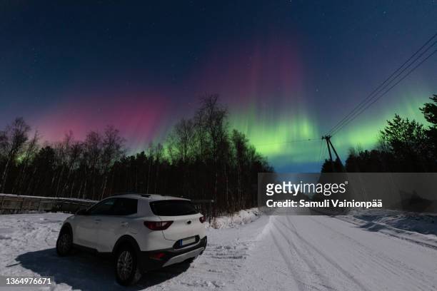 parked car and red and green northern lights, hailuoto, finland - oulu finland stock pictures, royalty-free photos & images