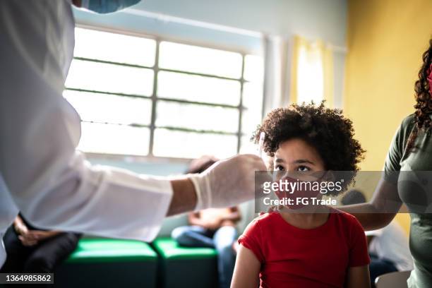 doctor preparing and showing vaccine to apply in a girl - brazil covid stock pictures, royalty-free photos & images