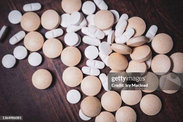 pills representing the dangers of drug interaction and self-medication - pills fotografías e imágenes de stock