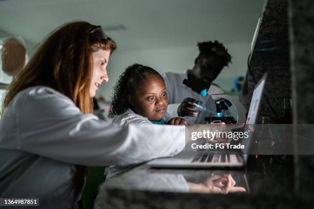 students using laptop in the lab - including person with special needs - real life science stock pictures, royalty-free photos & images