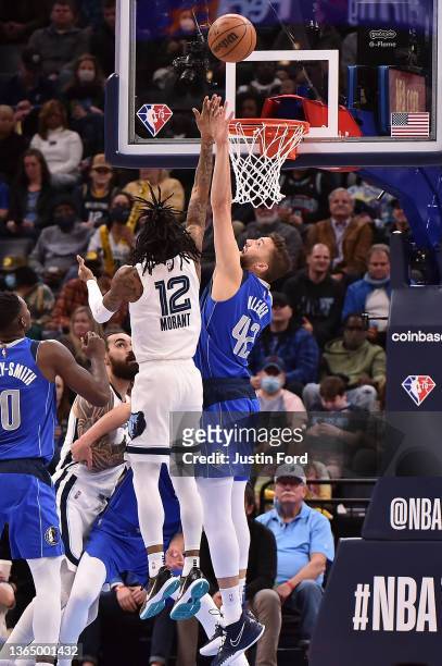 Ja Morant of the Memphis Grizzlies shoots against Maxi Kleber of the Dallas Mavericks during the game at FedExForum on January 14, 2022 in Memphis,...