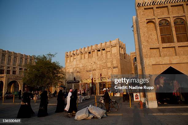 Qatari people in their traditional clothes called dishdasha and abaya are pictured at Souq Waqif on December 26, 2011 in Doha, Qatar. The The FIFA...