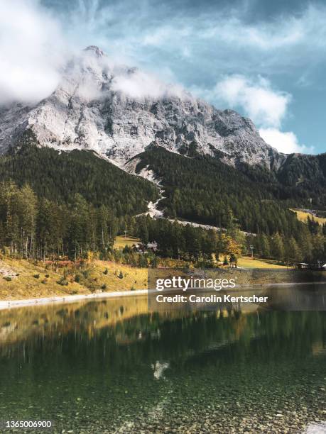 mountain lake with trees and mountains in the background - zugspitze mountain stock pictures, royalty-free photos & images