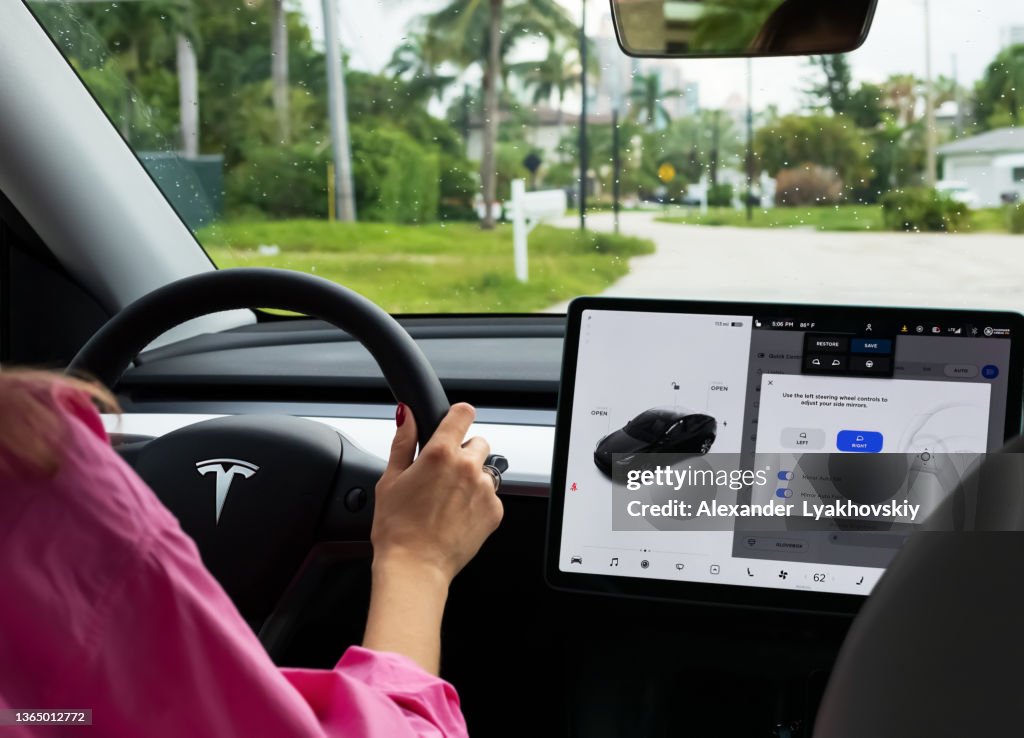 Cockpit with LCD touch screen of electric car Tesla Model Y during drive.