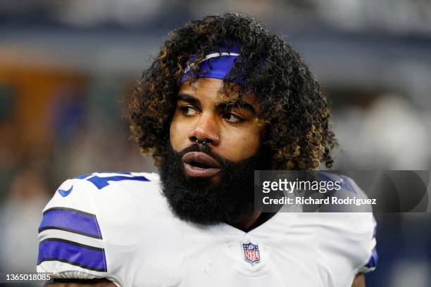 Ezekiel Elliott of the Dallas Cowboys looks on during pregame warm-ups prior to a game against the San Francisco 49ers in the NFC Wild Card Playoff...