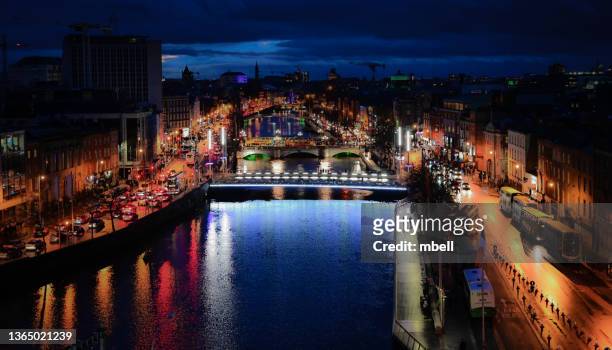 aerial view of dublin along the banks of the river liffey at night during st patrick's day celebration - dublin ireland - dublin city skyline ストックフォトと画像