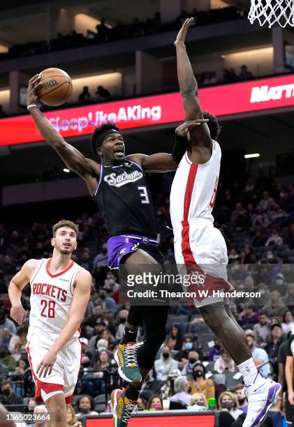 Terence Davis of the Sacramento Kings shoots over Jae'Sean Tate of the Houston Rockets during the first quarter at Golden 1 Center on January 14,...