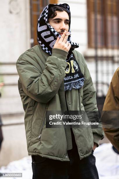 Guest outside Magliano fashion show wearing a football scarf during the Milan Men's Fashion Week - Fall/Winter 2022/2023 on January 16, 2022 in...