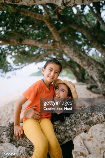 happy mother and young daughter on beach - eurasian ethnicity stock pictures, royalty-free photos & images