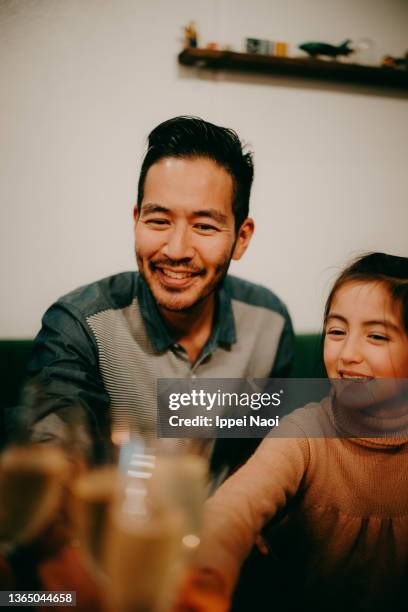 father and young daughter having a toast at home - eurasian ethnicity stock pictures, royalty-free photos & images