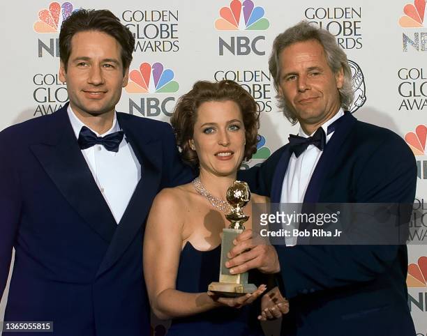 Files Chris Carter joins cast members Gillian Anderson and David Duchovny backstage at Golden Globe Awards Show, January 19, 1997 in Beverly Hills,...