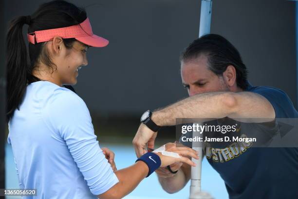 Emma Raducanu of Great Britain gets attention to her hand from her team at Albert Park courts during day one of the 2022 Australian Open on January...